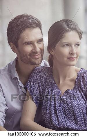 Stock Photography - "Couple sitting together, looking away, portrait". Fotosearch