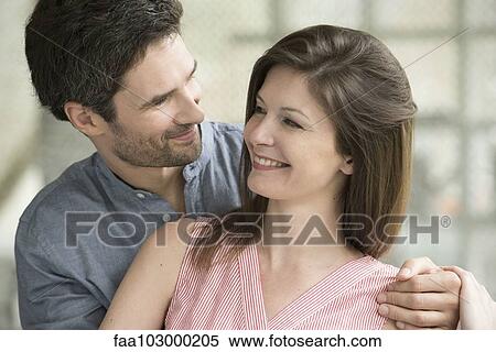 Couple smiling at each other View Large Photo Image Stock Photography - Couple smiling at each other. Fotosearch