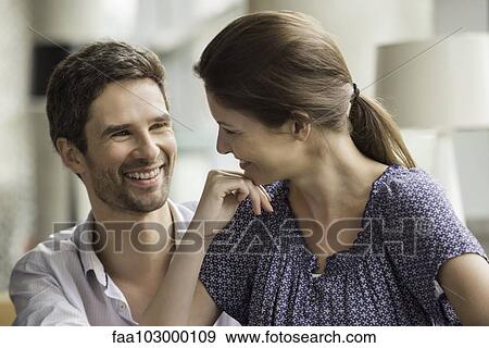 Couple smiling together at home View Large Photo Image Stock Photo - Couple smiling together at home. Fotosearch