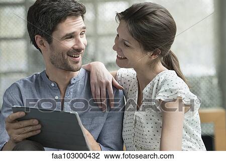 Stock Image - Couple using digital tablet together at home. Fotosearch