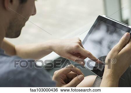 "Couple using digital tablet together, cropped" View Large Photo Image Stock Photograph - "Couple using digital tablet together, cropped". Fotosearch
