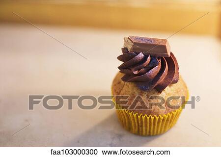 Cupcake with chocolate frosting View Large Photo Image Stock Image - Cupcake with chocolate frosting. Fotosearch