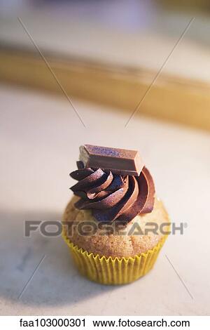 Cupcake with chocolate frosting View Large Photo Image Stock Image - Cupcake with chocolate frosting. Fotosearch