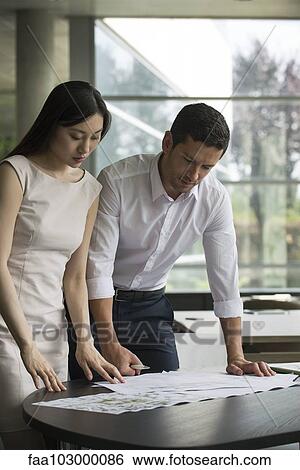 Engineer and associate working closely together on project View Large Photo Image Stock Photograph - Engineer and associate working closely together on project. Fotosearch
