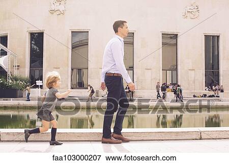 Stock Photo - Father and young daughter spending time together in park. Fotosearch