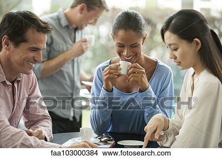 Friends enjoying coffee break View Large Photo Image Picture - Friends enjoying coffee break. Fotosearch