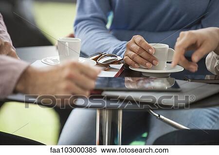 "Friends having coffee in cafe, cropped" View Large Photo Image Stock Photography - "Friends having coffee in cafe, cropped". Fotosearch