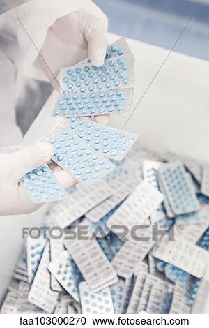 Inspecting packages of prescription drugs in manufacturing plant View Large Photo Image Stock Image - Inspecting packages of prescription drugs in manufacturing plant. Fotosearch