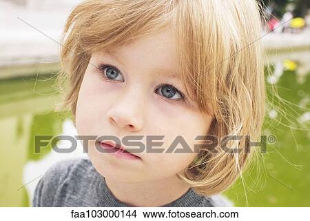 Picture - "Little girl looking away in thought, portrait". Fotosearch
