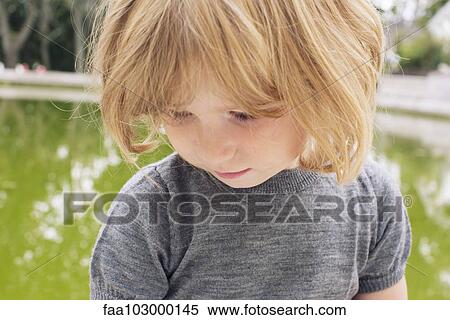 "Little girl looking down, portrait" View Large Photo Image Stock Photography - "Little girl looking down, portrait". Fotosearch