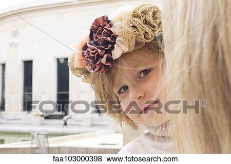 "Little girl peeking around mother's head, portrait" View Large Photo Image Stock Photo - "Little girl peeking around mother's head, portrait". Fotosearch