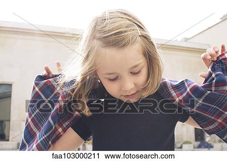 Little girl playing outdoors View Large Photo Image Stock Image - Little girl playing outdoors. Fotosearch