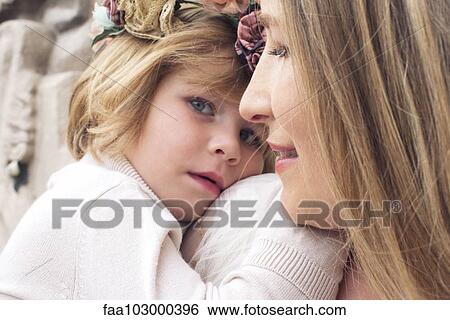 Little girl resting her head on her mother's shoulder View Large Photo Image Stock Photograph - Little girl resting her head on her mother's shoulder. Fotosearch