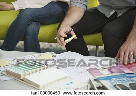 "Man and woman looking at paint swatches and blueprints, cropped" View Large Photo Image Stock Image - "Man and woman looking at paint swatches and blueprints, cropped". Fotosearch