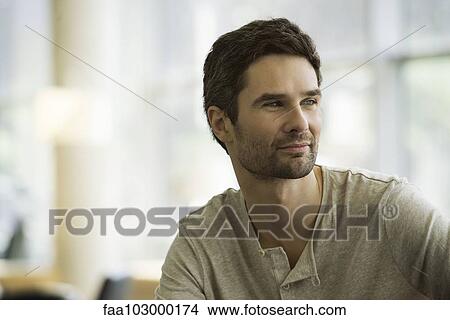 Picture - "Man looking away in thought, portrait". Fotosearch