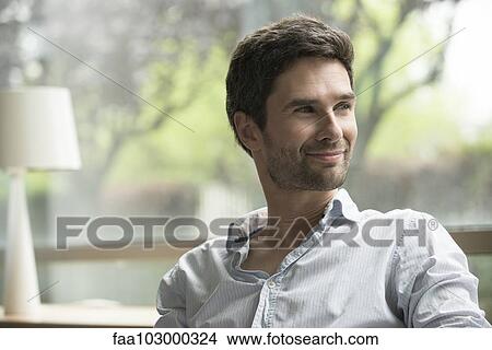 "Man looking away in thought, smiling" View Large Photo Image Picture - "Man looking away in thought, smiling". Fotosearch