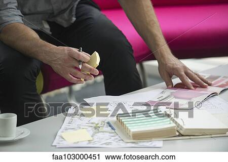 Man looking through catalog of color swatches View Large Photo Image Stock Image - Man looking through catalog of color swatches. Fotosearch