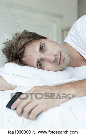 Man relaxing on bed View Large Photo Image Stock Photography - Man relaxing on bed. Fotosearch