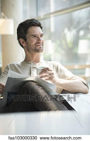 Man relaxing with coffee and newspaper View Large Photo Image Stock Image - Man relaxing with coffee and newspaper. Fotosearch