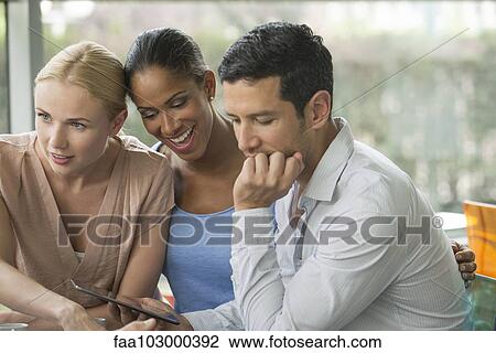 Man showing digital tablet to friends View Large Photo Image Stock Image - Man showing digital tablet to friends. Fotosearch