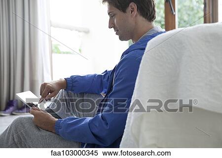 Man using digital tablet at home View Large Photo Image Stock Photography - Man using digital tablet at home. Fotosearch
