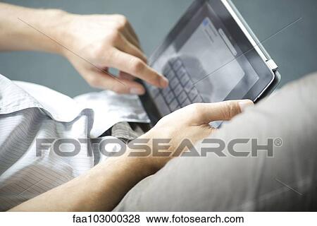 Stock Photo - "Man using digital tablet, cropped". Fotosearch