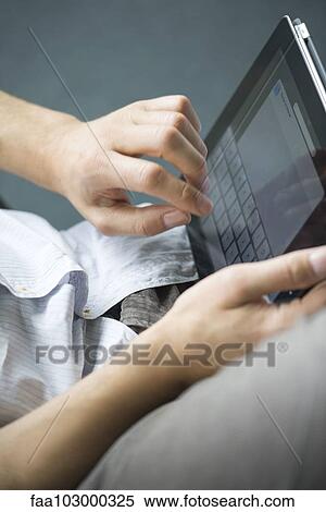 "Man using digital tablet, cropped" View Large Photo Image Stock Photography - "Man using digital tablet, cropped". Fotosearch