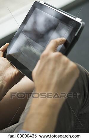 Stock Photography - "Man using digital tablet, cropped". Fotosearch