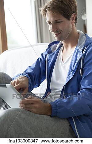 Stock Photo - Man using digital tablet. Fotosearch