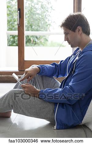 Man using digital tablet View Large Photo Image Stock Photograph - Man using digital tablet. Fotosearch
