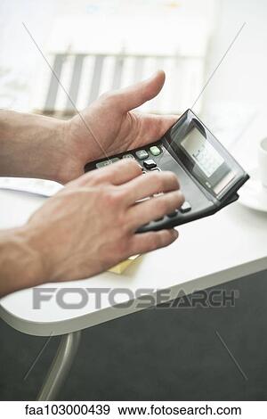 Man's hands holding calculator View Large Photo Image Stock Photo - Man's hands holding calculator. Fotosearch