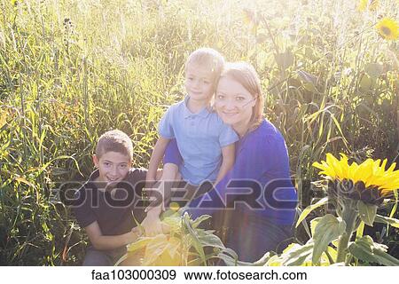 "Mother and young sons together in field of sunflowers, portrait" View Large Photo Image Stock Photo - "Mother and young sons together in field of sunflowers, portrait". Fotosearch
