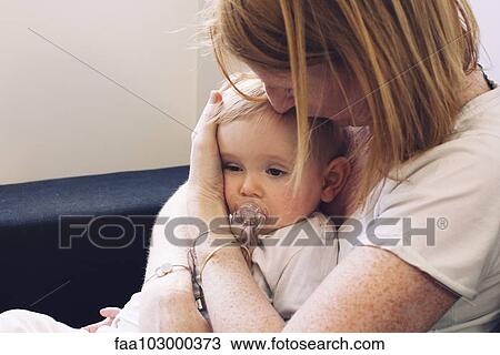 Mother holding infant on lap View Large Photo Image Stock Image - Mother holding infant on lap. Fotosearch