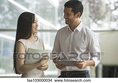 Picture - Office mates chatting. Fotosearch