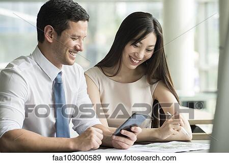 Stock Photo - Officer workers collaborating. Fotosearch