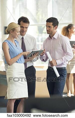 Professionals collaborating using digital tablet View Large Photo Image Stock Image - Professionals collaborating using digital tablet. Fotosearch