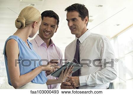 Professionals collaborating using digital tablet View Large Photo Image Stock Image - Professionals collaborating using digital tablet. Fotosearch