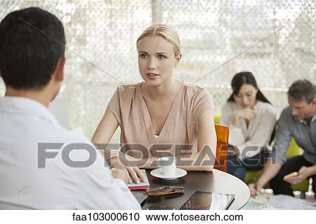 Professionals having casual meeting in cafe View Large Photo Image Stock Image - Professionals having casual meeting in cafe. Fotosearch