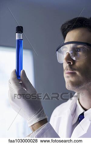 Stock Photo - Researcher examining test tube in laboratory. Fotosearch