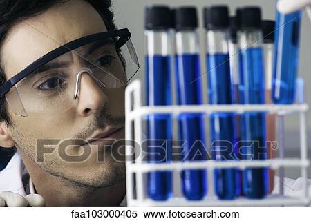 Researcher scrutinizing test tubes in laboratory View Large Photo Image Stock Photography - Researcher scrutinizing test tubes in laboratory. Fotosearch