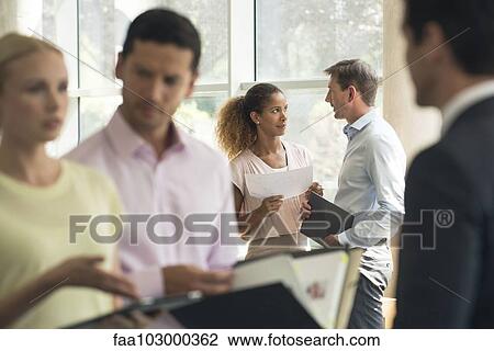 Stock Image - Sales professionals meeting with clients. Fotosearch