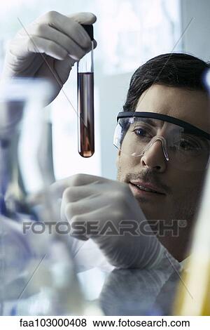 Scientist conducting experiment in laboratory View Large Photo Image Stock Photo - Scientist conducting experiment in laboratory. Fotosearch