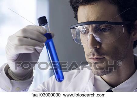 Scientist examining test tube in lab View Large Photo Image Stock Image - Scientist examining test tube in lab. Fotosearch
