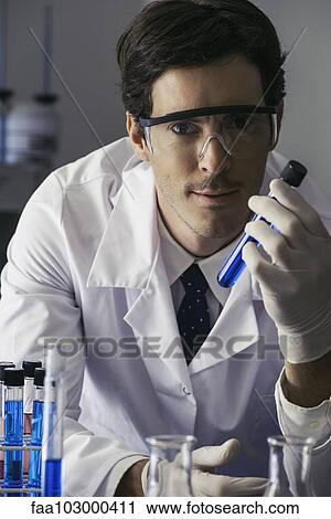 "Scientist holding test tube in lab, looking at camera with determined expression" View Large Photo Image Stock Image - "Scientist holding test tube in lab, looking at camera with determined expression". Fotosearch