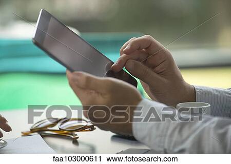 Stock Image - Using digital tablet. Fotosearch