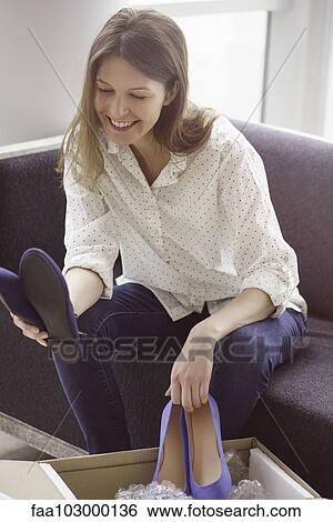 Woman admiring new shoes purchased online View Large Photo Image Stock Photograph - Woman admiring new shoes purchased online. Fotosearch