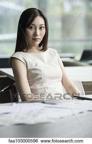 Stock Photograph - "Woman at desk, portrait". Fotosearch