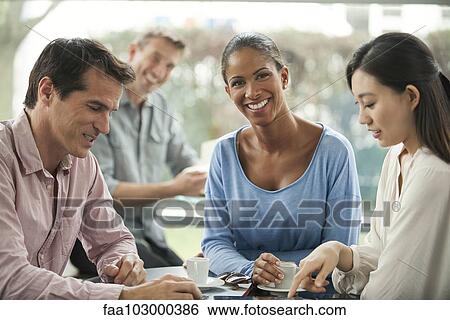 Woman enjoying coffee break with colleagues View Large Photo Image Stock Photograph - Woman enjoying coffee break with colleagues. Fotosearch