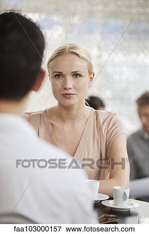 Stock Photo - Woman having coffee in cafe with man. Fotosearch