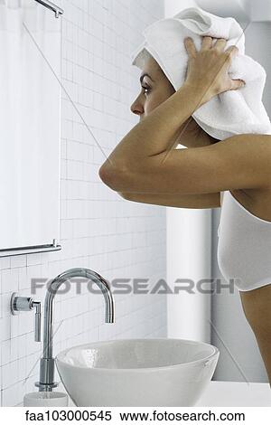 "Woman in front of bathroom mirror, drying hair with towel" View Large Photo Image Stock Photography - "Woman in front of bathroom mirror, drying hair with towel". Fotosearch
